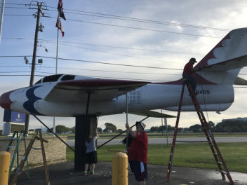 Volunteers painting and restoring the F-84F tail